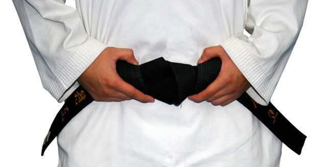 Boy wearing his Karate black belt.
